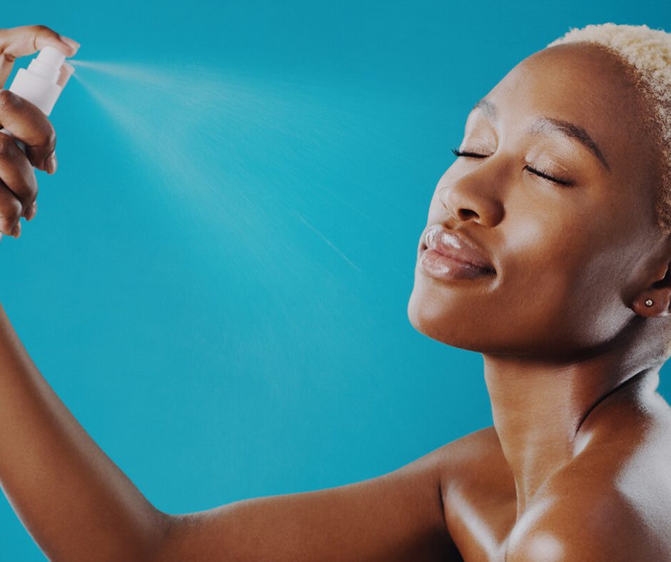 Applying setting spray to lock makeup in place.
